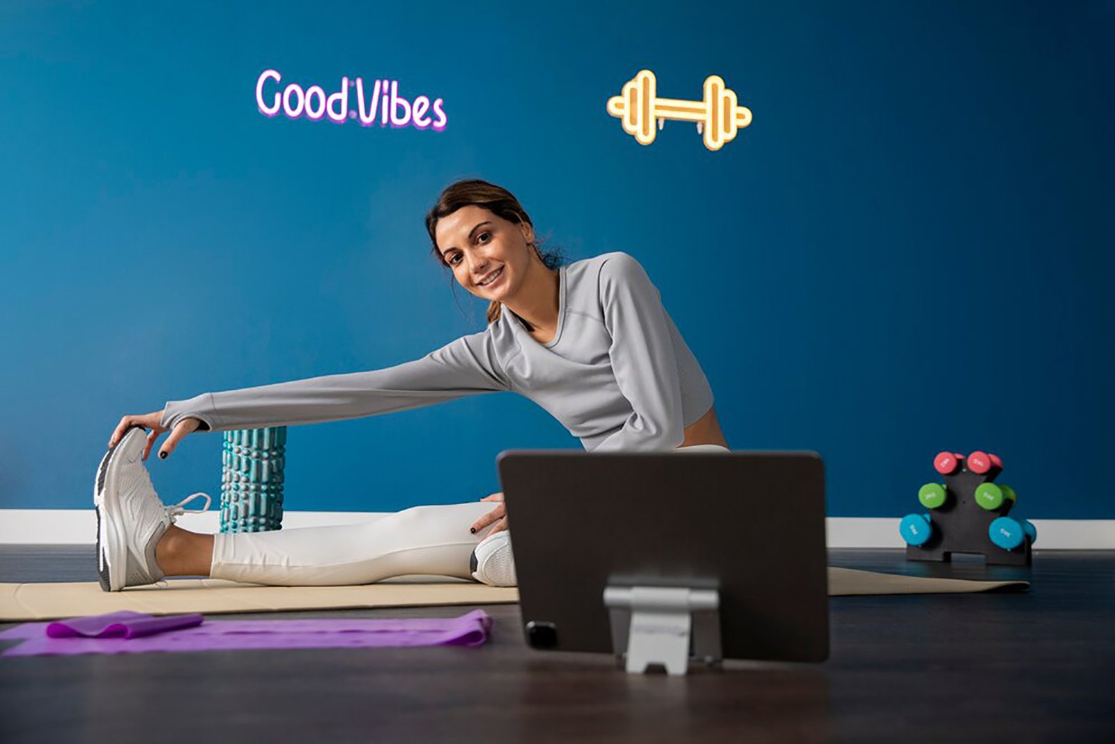 female-fitness-instructor-using-tablet-teach-class-from-home_23-2149320144