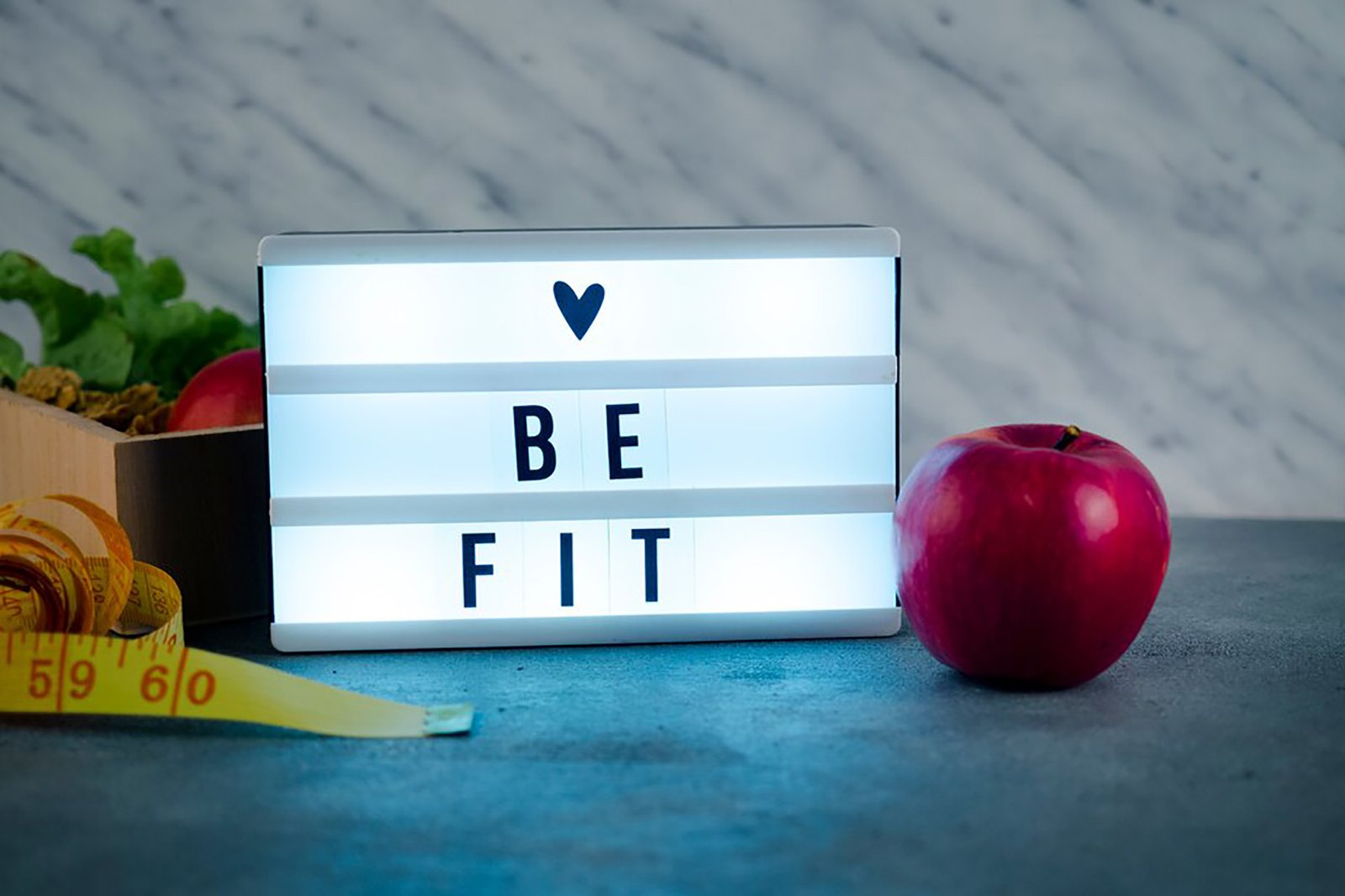 shiny-love-be-fit-inscription-board-with-apple_23-2148035066